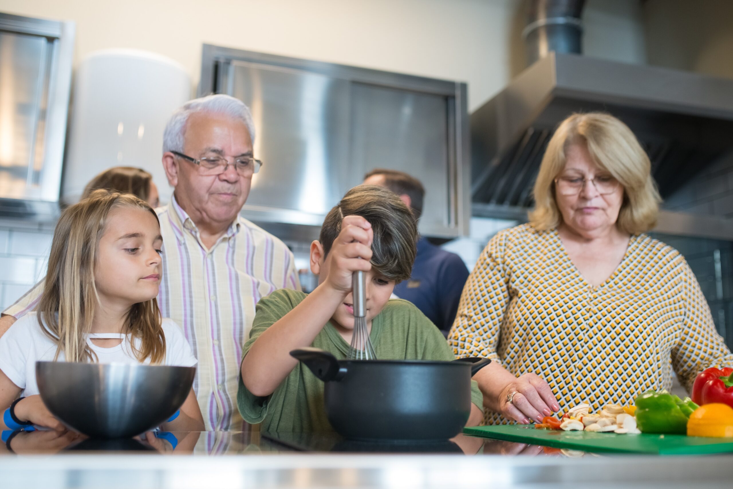 children cooking with grandparents